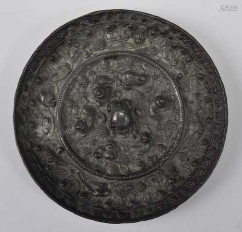 A Chinese bronze 'mythical beast and grapevine' mirror, cast...