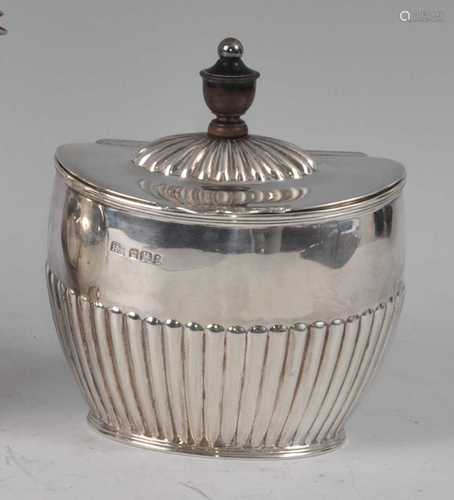 A late Victorian silver tea caddy, of half-reeded oval form,...