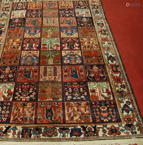 A Turkish woollen rug, the ground decorated with five rows o...