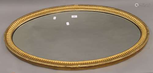 A 19th century oval gilt framed mirror. 90 cm wide, 53 cm hi...