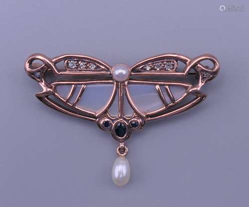 An Art Nouveau style 10 K gold, pearl and diamond brooch. 4....