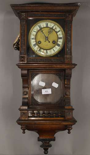 A 19th century walnut wall clock. 58 cm high.