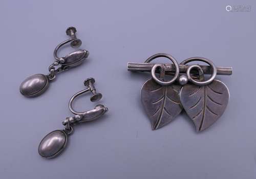 A silver Georg Jensen brooch and matching earrings. Brooch 4...