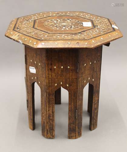 An Indian inlaid folding table. 30 cm diameter.