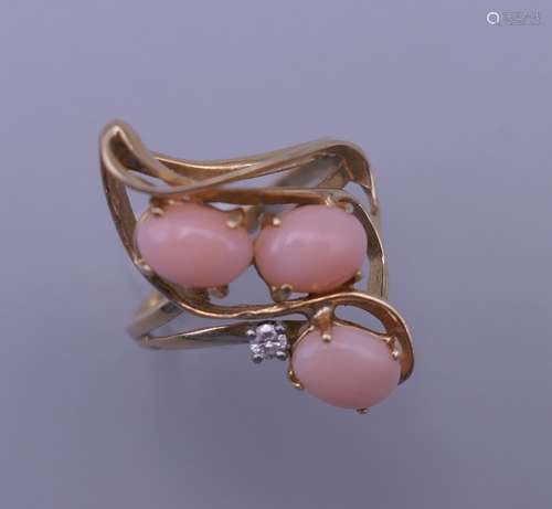 A 14 K gold, coral and diamond ring. 4.4 grammes total weigh...