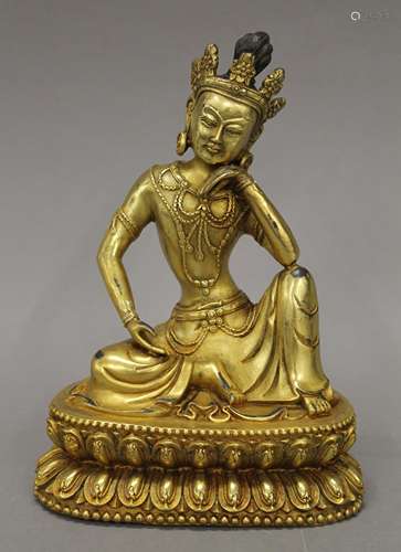 A gilt bronze model of Buddha. 20.5 cm high.