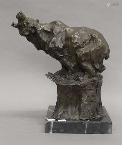 An abstract bronze model of a bear mounted on a plinth base....