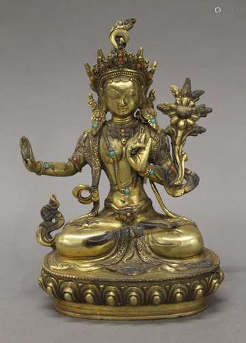 A gilt bronze model of Buddha decorated with coral and turqu...