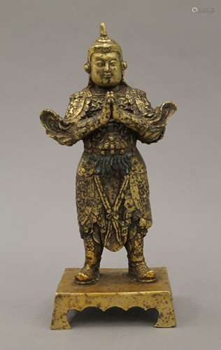 A gilded bronze Chinese figure of a warrior on a shaped rect...