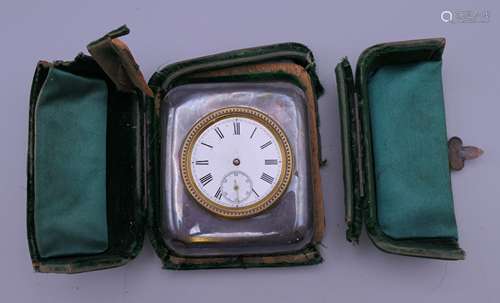 A silver cased travel clock. Case 6.5 cm x 7.5 cm.