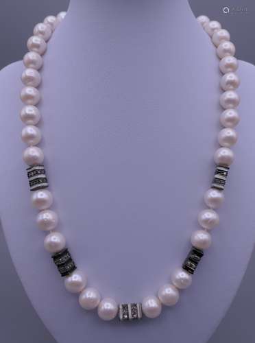 An 18 ct white gold mounted and diamond section pearl neckla...