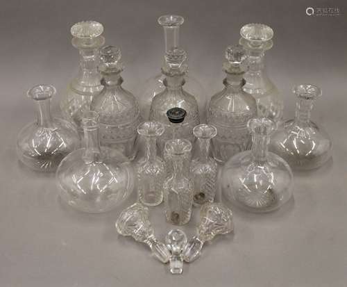 A quantity of various decanters, etc.