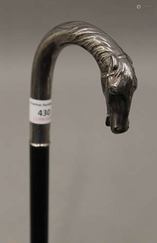 A walking stick with horse head handle in silver, crown and ...