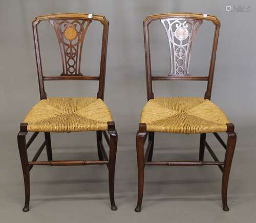 A pair of Victorian inlaid rush seated chairs.