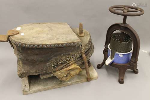 A set of antique foot bellows and a cast iron juicing press....