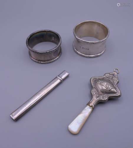 Two silver napkin rings, a baby's rattle and a silver fruit ...