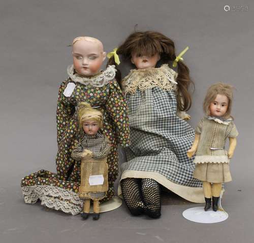 Four vintage porcelain headed dolls. The largest 47 cm tall.