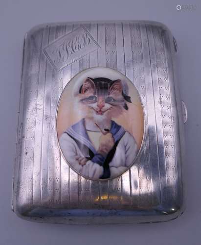 A silver cigarette case decorated with a cat in sailor's uni...