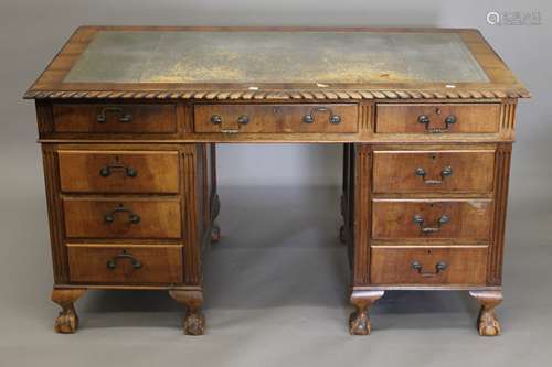 An early 20th century walnut pedestal desk. 136 cm wide x 75...