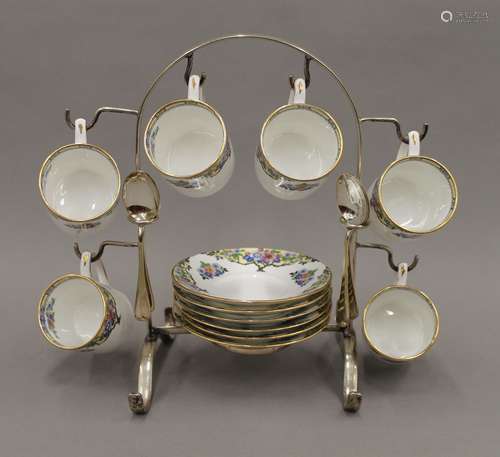 An early 20th century porcelain coffee set on a silver plate...