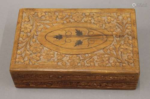 A set of bone and ebony dominoes in an Eastern carved box. T...