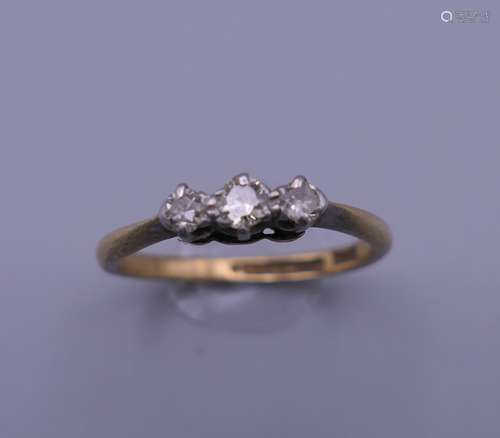 An 18 ct gold and platinum three stone diamond ring. Ring si...