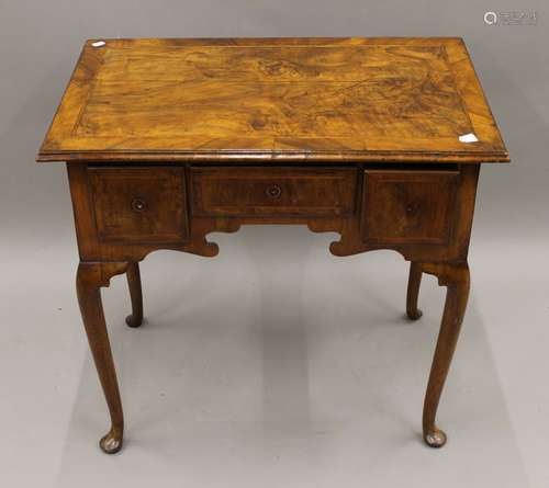 A Georgian walnut lowboy. 75 cm wide, 72 cm high, 48.5 cm de...