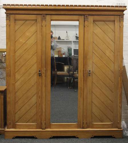 An Arts and Crafts inlaid ash triple wardrobe, en-suite (see...