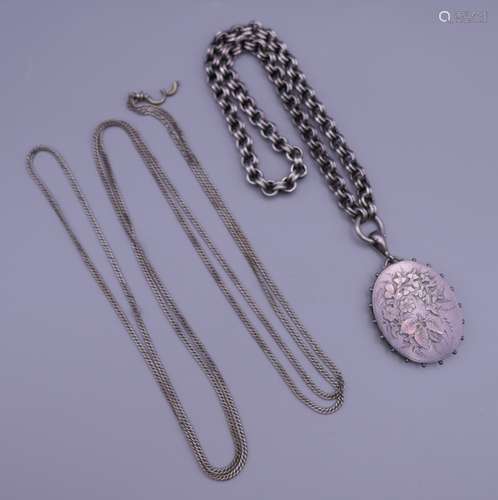 A Victorian silver locket and two chains. Locket 4.5 cm high...