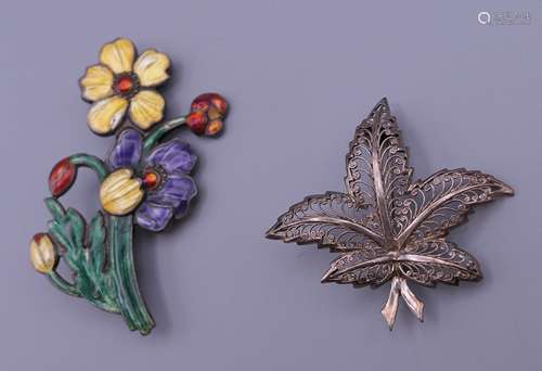 A silver enamel brooch and a silver leaf form brooch. 6.75 c...