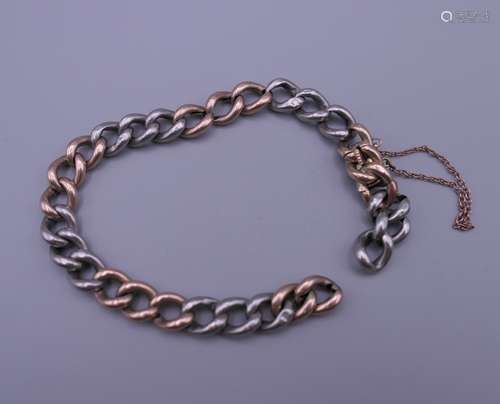 A silver and gold bracelet. 20 cm long. 16.2 grammes total w...