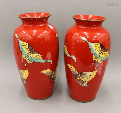 A pair of red ground porcelain vases decorated with butterfl...