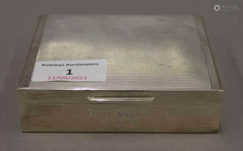 A silver cigarette box. 10 cm wide. 262.8 grammes total weig...