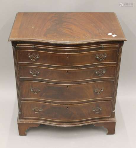 A 20th century Serpentine chest of drawers. 70.5 cm wide.