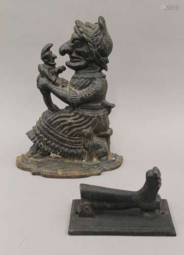 A cast iron Punch and Judy door stop, and a boot form door k...