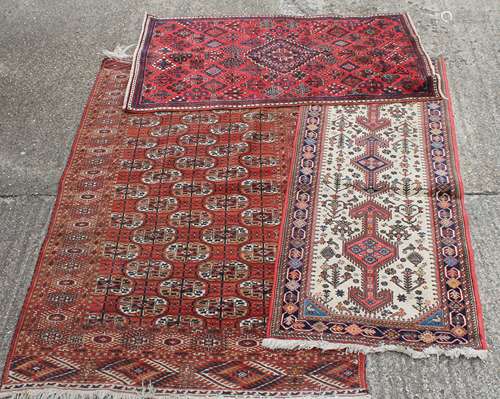 Three Persian wool rugs. The largest 131 x 205 cm.