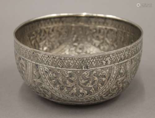 A 19th century hand tooled Thai silver bowl, stamps to base....