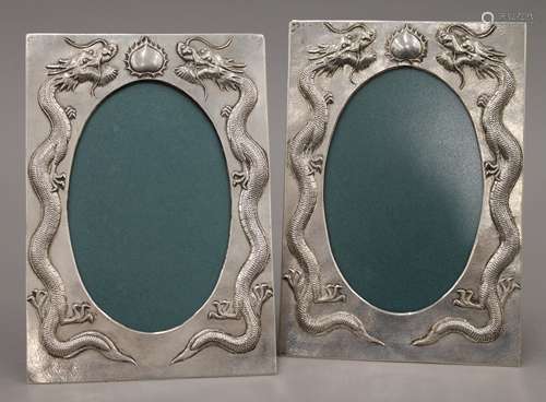 A pair of Chinese silver frames decorated with dragons, with...