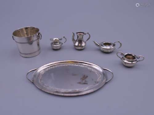 Six pieces of silver dolls house items. Tray 6 cm wide inclu...