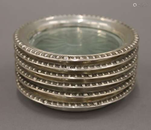 Six sterling silver mounted glass coasters. 9.5 cm diameter.