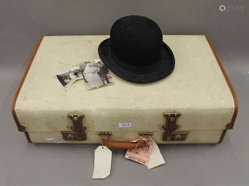 A vintage suitcase and a bowler hat. Approx size 7.25.