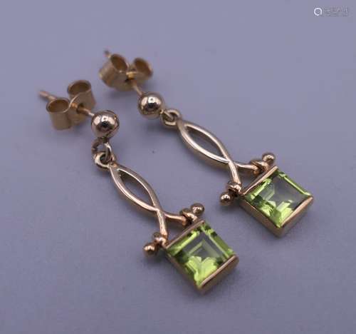 A pair of 9 ct gold peridot drop earrings. 2.25 cm high.