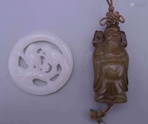 A white jade bird pendant and a jade god pendant. Bird penda...