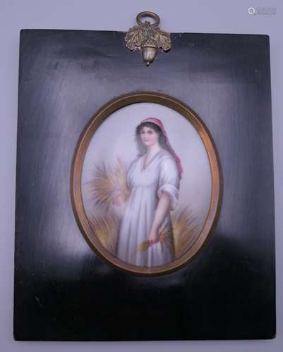 A porcelain plaque depicting 'Ruth the Gleaner' standing hol...