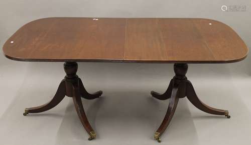 A mahogany twin pillar dining table. 180 cm long x 105 cm wi...