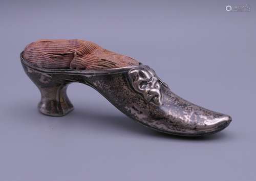 A silver shoe form pin cushion. 8 cm long, 2.5 cm high.