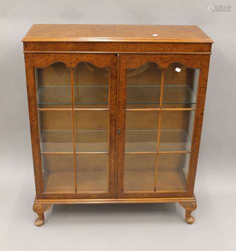 An early 20th century walnut display cabinet. 90 cm wide.