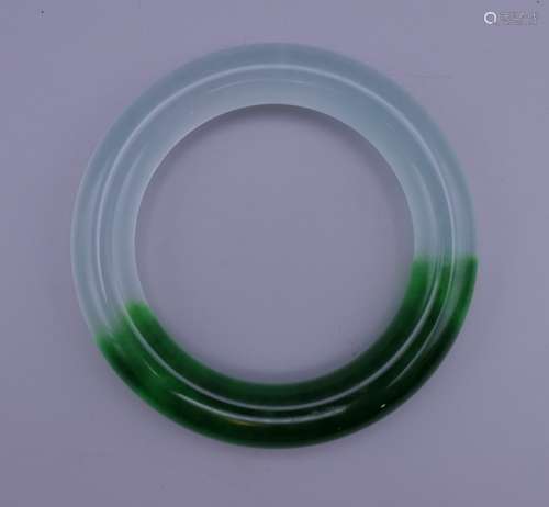 A two tone jade bangle. 6.26 cm inner diameter.