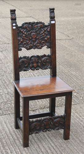 A Jacobean style carved walnut solid seated chair. 123 cm hi...