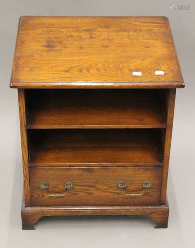 A modern oak bedside cupboard and cane back chair. The forme...